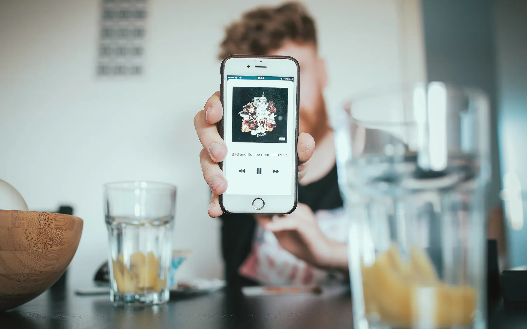 A phone held up showing an app interface